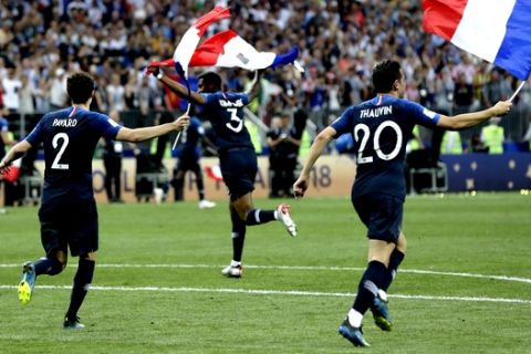 From left, France's Benjamin Pavard, Presnel Kimpembe and Florian Thauvin celebrate at the end of the final match between France and Croatia at the 2018 soccer World Cup in the Luzhniki Stadium in Moscow, Russia, Sunday, July 15, 2018. France won 4-2. (AP Photo/Petr David Josek)