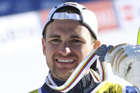 Greece's Aj Ginnis shows the silver medal of the men's World Championship slalom, in Courchevel, France, Sunday Feb. 19, 2023. (AP Photo/Marco Trovati)