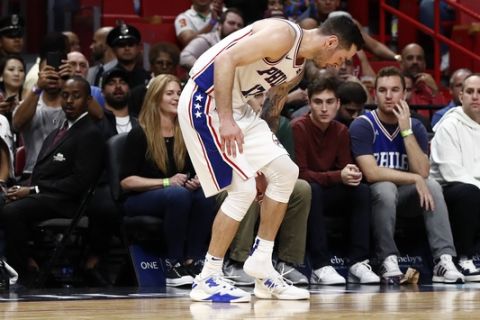 Philadelphia 76ers guard JJ Redick runs down court with one sneaker during the first half in the first quarter of an NBA basketball game against Miami Heat, Monday, Nov. 12, 2018, in Miami. (AP Photo/Brynn Anderson)