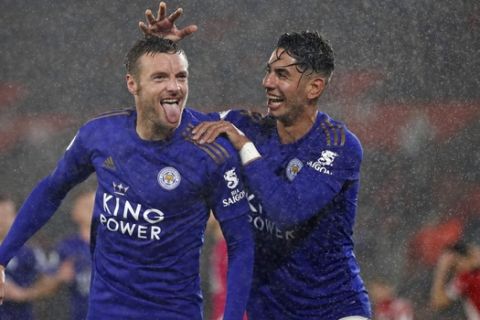 Leicester's Jamie Vardy, left, celebrates with Ayoze Perez after scoring his side's fifth goal during the English Premier League soccer match between Southampton and Leicester City at St Mary's stadium in Southampton, England Friday, Oct., 25, 2019. (AP Photo/Alastair Grant)