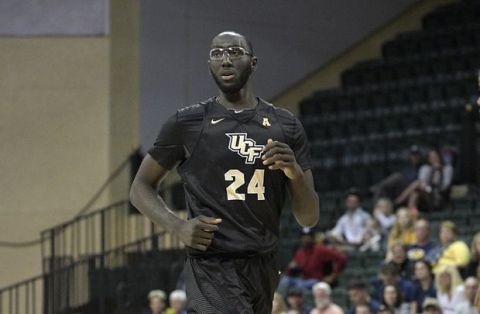 Central Florida center Tacko Fall (24) jogs up the court during the first half of an NCAA college basketball game against West Virginia at the AdvoCare Invitational tournament Friday, Nov. 24, 2017, in Lake Buena Vista, Fla. West Virginia won 83-45. (AP Photo/Phelan M. Ebenhack)