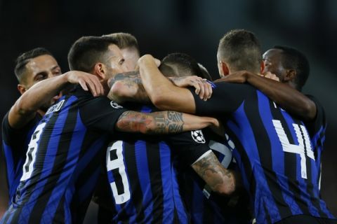 Inter players celebrate scoring their side's first goal during a Group B Champions League soccer match between PSV and Inter Milan at the Philips stadium in Eindhoven, Netherlands, Wednesday, Oct. 3, 2018. (AP Photo/Peter Dejong)