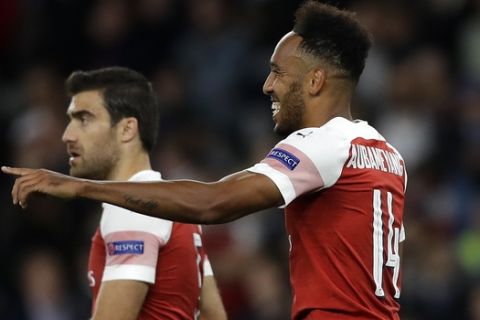 Arsenal's Pierre-Emerick Aubameyang, right, celebrates after scoring the opening goal during the Europa League Group E soccer match between Arsenal and Vorskla in London, England, Thursday, Sept. 20, 2018. (AP Photo/Kirsty Wigglesworth)