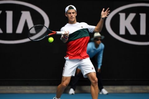 Argentina's Diego Schwartzman hits a return against Serbia's Dusan Lajovic during their men's singles match on day five of the Australian Open tennis tournament in Melbourne on January 24, 2020. (Photo by Manan VATSYAYANA / AFP) / IMAGE RESTRICTED TO EDITORIAL USE - STRICTLY NO COMMERCIAL USE (Photo by MANAN VATSYAYANA/AFP via Getty Images)