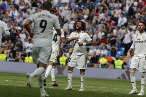 Real Madrid's Marcelo, centre, celebrates after scoring his side's 1st goal during a Spanish La Liga soccer match between Real Madrid and Levante at the Santiago Bernabeu stadium in Madrid, Spain, Saturday, Oct. 20, 2018. (AP Photo/Paul White)