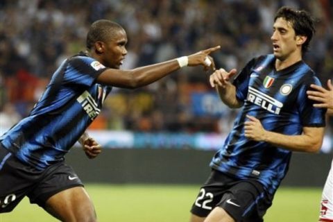 Inter Milan forward Samuel Eto'o, of Cameroon, left, celebrates after scoring with his teammate Argentine forward Diego Milito during a Serie A soccer match between Inter Milan and Bari at the San Siro stadium in Milan, Italy, Wednesday, Sept. 22, 2010. (AP Photo/Luca Bruno)