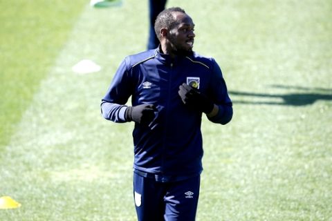 Jamaica's Usain Bolt trains with the Central Coast Mariners soccer team in Newcastle, Tuesday, Aug. 21, 2018. Bolt, who holds the world records for the 100- and 200-meter sprints and is an eight-time Olympic gold medalist, is hoping to impress the coaching staff enough to earn a contract with the Mariners for the 2018-19 season in Australia's top-flight competition. (AP Photo/Steve Christo)