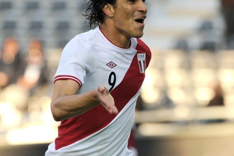 Peruvian forward Paolo Guerrero celebrates after scoring his team´s second goal against Venezuela during the 2011 Copa America football tournament third-place match held at the Ciudad de La Plata stadium in La Plata, 59 Km south of Buenos Aires, on July 23, 2011.   AFP PHOTO / ALEJANDRO PAGNI (Photo credit should read ALEJANDRO PAGNI/AFP/Getty Images)