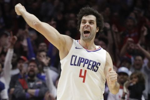 Los Angeles Clippers' Milos Teodosic celebrates his three-point basket during the second half of an NBA basketball game against the Toronto Raptors, Monday, Dec. 11, 2017, in Los Angeles. The Clippers won 96-91. (AP Photo/Jae C. Hong)