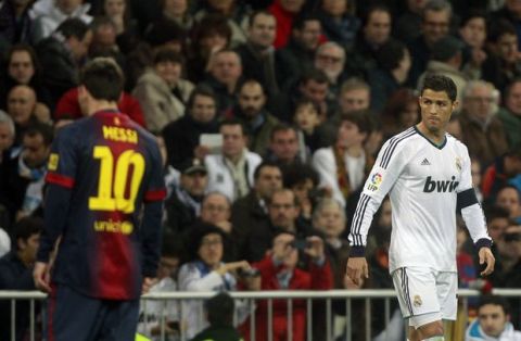 FC Barcelona's Lionel Messi from Argentina, left, and Real Madrid's Cristiano Ronaldo from Portugal, right, walk on the pitch during a semifinal, first leg, Copa del Rey soccer match at the Santiago Bernabeu stadium in Madrid, Spain, Wednesday, Jan. 30, 2013. (AP Photo/Andres Kudacki)