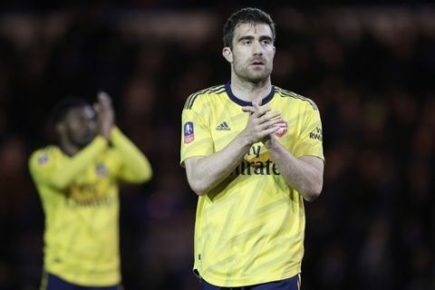 Arsenal's Sokratis Papastathopoulos celebrates at the end of the English FA Cup fifth round soccer match between Portsmouth and Arsenal at Fratton Park stadium in Portsmouth, England, Monday, March 2, 2020. Arsenal won 2-0. (AP Photo/Kirsty Wigglesworth)