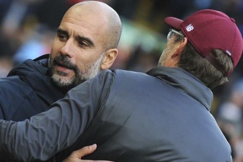 Manchester City manager Josep Guardiola, left, hugs Liverpool manager Juergen Klopp prior to the English Premier League soccer match between Liverpool and Manchester City at Anfield stadium in Liverpool, England, Sunday, Oct. 7, 2018. (AP Photo/Rui Vieira)
