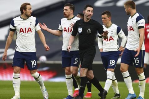Tottenham players protest to referee during the English Premier League soccer match between Tottenham Hotspur and Manchester United at the Tottenham Hotspur Stadium in London, Sunday, April 11, 2021. (Clive Rose/Pool via AP)
