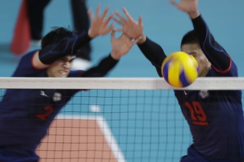 Taiwan's Liu Hongiie,left, and Chen Chienpin plays against Qatar during the men's volleyball bronze medal match at the 18th Asian Games in Jakarta, Indonesia, Saturday, Sept. 1, 2018. (AP Photo/Tatan Syuflana)