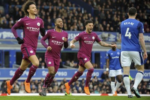 Manchester City's Leroy Sane, left, celebrates with teammates Raheem Sterling and Kyle Walker, right, after scoring his side's first goal during the English Premier League soccer match between Everton and Manchester City at Goodison Park in Liverpool, England, Saturday, March 31, 2018. (AP Photo/Rui Vieira)