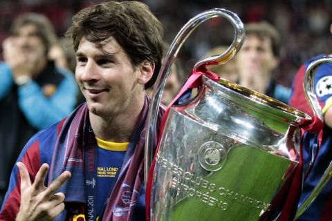 Barcelona's Lionel Messi celebrates with the trophy after winning the Champions League final soccer match against Manchester United at Wembley Stadium, London, Saturday, May 28, 2011. (AP Photo/Jon Super)