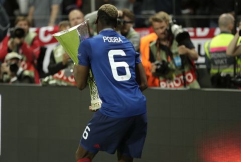 Manchester's Paul Pogba dances with the trophy after winning 2-0 during the soccer Europa League final between Ajax Amsterdam and Manchester United at the Friends Arena in Stockholm, Sweden, Wednesday, May 24, 2017. (AP Photo/Michael Sohn)