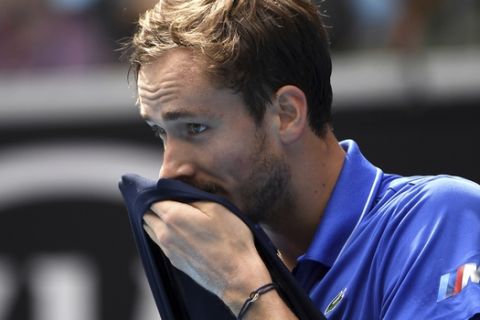 Russia's Daniil Medvedev wipes the sweat from his face during his fourth round match against Switzerland's Stan Wawrinka at the Australian Open tennis championship in Melbourne, Australia, Monday, Jan. 27, 2020. (AP Photo/Andy Brownbill)