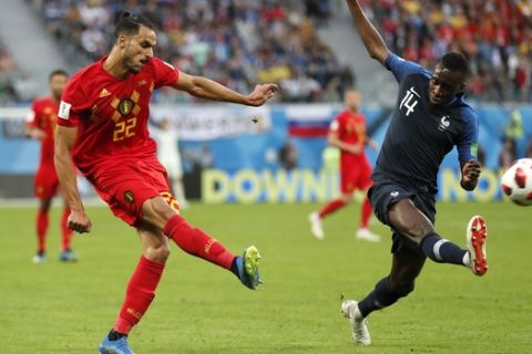 Belgium's Nacer Chadli, left shoots at goal as France's Blaise Matuidi attempts to block during the semifinal match between France and Belgium at the 2018 soccer World Cup in the St. Petersburg Stadium in, St. Petersburg, Russia, Tuesday, July 10, 2018. (AP Photo/Natacha Pisarenko)