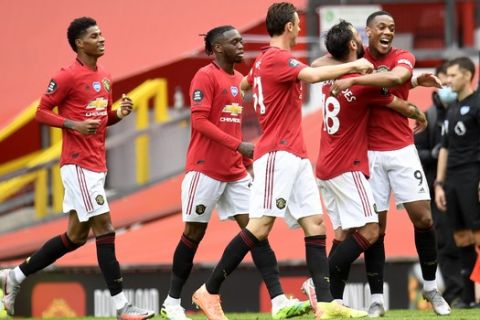 Manchester United's Anthony Martial (9) is congratulated by teammates after scoring a goal during the English Premier League soccer match between Manchester United and Bournemouth at Old Trafford stadium in Manchester, England, Saturday, July 4, 2020. (Peter Powell/Pool via AP)