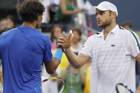 Andy Roddick, right, shakes hands with Rafael Nadal of Spain after their quarterfinal match at the U.S. Open tennis tournament in New York, Friday, Sept. 9, 2011. (AP Photo/Mike Groll)