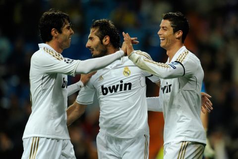 Real Madrid's Portuguese forward Cristiano Ronaldo (R) celebrates with teammates Real Madrid's Brazilian midfielder Kaka (L) and Real Madrid's German born Turkish midfielder Hamit Altintop (C) after scoring during the UEFA Champions League second leg quarter-final football match Real Madrid against Apoel Nicosia at the Santiago Bernabeu Stadium in Madrid on April 04, 2012.AFP PHOTO/ DANI POZO (Photo credit should read DANI POZO/AFP/Getty Images)