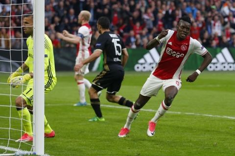 Ajax's Bertrand Traore, right, celebrates after scoring the fourth goal of his team during the first leg semi final soccer match between Ajax and Olympique Lyon in the Amsterdam ArenA stadium, Netherlands, Wednesday, May 3, 2017. (AP Photo/Peter Dejong)