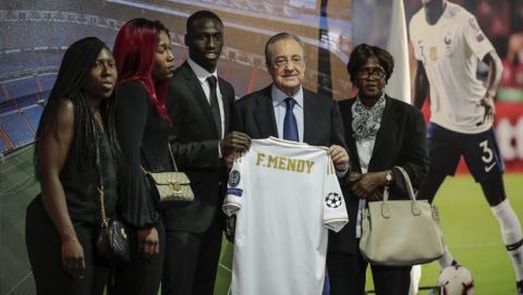 French soccer player Ferland Mendy, third from left, poses with his family and Real Madrid president Florentino Perez, second right, during his official presentation after signing for Real Madrid at the Santiago Bernabeu stadium in Madrid, Spain, Wednesday, June 19, 2019. (AP Photo/Manu Fernandez)