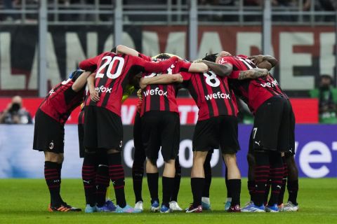 AC Milan players gather prior the kick off of the Serie A soccer match between AC Milan and Genoa, at the San Siro stadium in Milan, Italy, Friday, April 15, 2022. (AP Photo/Luca Bruno)