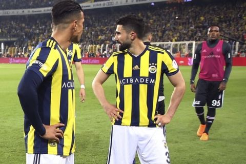 Besiktas, center, and Fenerbahce players leave the pitch after Besiktas coach Senol Gunes was injured by an object during the Turkish Cup semi-final second leg match between Besiktas and Fenerbahce in Istanbul, Thursday, April 19, 2018. The Turkish Cup semifinal between Fenerbahce and Besiktas was abandoned on Thursday after visiting coach Senol Gunes was injured by an object thrown from the stands. (AP Photo)