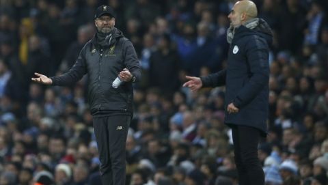 Liverpool's coach Juergen Klopp, left, and Manchester City's coach Pep Guardiola gesture from the side line during the English Premier League soccer match between Manchester City and Liverpool at the Etihad Stadium in Manchester, England, Thursday, Jan. 3, 2019.(AP Photo/Dave Thompson)