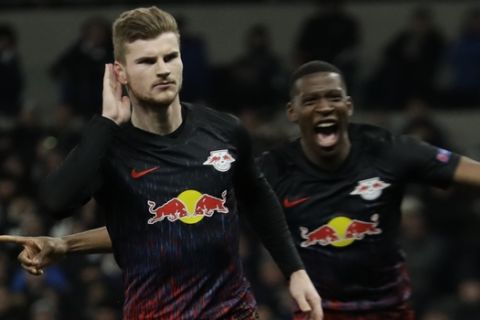 Leipzig's Timo Werner, left, celebrates after scoring his side's opening goal during a first leg, round of 16, Champions League soccer match between Tottenham Hotspur and Leipzig at the Tottenham Hotspur Stadium in London, England, Wednesday Feb. 19, 2020. (AP Photo/Matt Dunham)