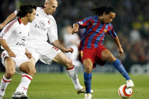 Barcelona's Ronaldinho of Brazil controls the ball as AC Milan's Jaap Stam of the Netherlands, center, and Andrea Pirlo look on, during a Champions League, second leg, semi-final soccer match between Barcelona and AC Milan, at the Camp Nou stadium in Barcelona, Spain, Wednesday, April 26, 2006. (AP Photo/Luca Bruno)