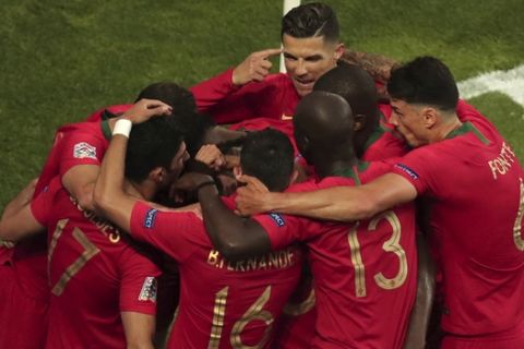 Portugal's Goncalo Guedes celebrates with teammates after scoring his side's opening goal during the UEFA Nations League final soccer match between Portugal and Netherlands at the Dragao stadium in Porto, Portugal, Sunday, June 9, 2019. (AP Photo/Luis Vieira)