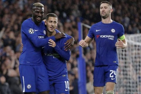 Chelsea's Tiemoue Bakayoko, left, celebrates with his teammates Eden Hazard, center, and Gary Cahill after scoring during the Champions League group C soccer match between Chelsea and Qarabag at Stamford Bridge stadium in London, Tuesday, Sept. 12, 2017. (AP Photo/Kirsty Wigglesworth)