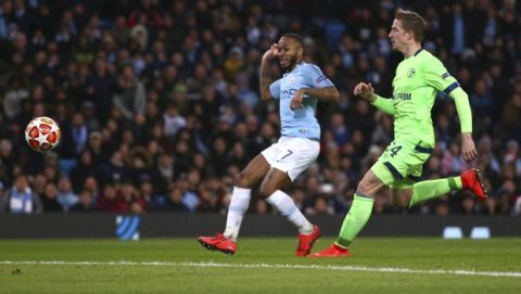 Manchester City's Raheem Sterling, left, scores past Schalke's Bastian Oczipka his side's fourth goal during the Champions League round of 16 second leg, soccer match between Manchester City and Schalke 04 at Etihad stadium in Manchester, England, Tuesday, March 12, 2019. (AP Photo/Dave Thompson)