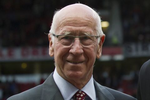 FILE - In this file photo dated Tuesday May 6, 2014, former soccer player Bobby Charlton at Old Trafford Stadium in Manchester, England.  Manchester United and England soccer great Bobby Charlton has been diagnosed with dementia, it is revealed Sunday Nov. 1, 2020.  (AP Photo/Jon Super, FILE)
