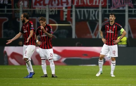 From left, AC Milan's Gonzalo Higuain, Lucas Biglia and Alessio Romagnoli react after Betis' Toni Sanabria scored his side's opening goal during the Europa League, Group F soccer match between AC Milan and Betis, at the San Siro Stadium in Milan, Italy, Thursday, Oct. 25, 2018. (AP Photo/Antonio Calanni)