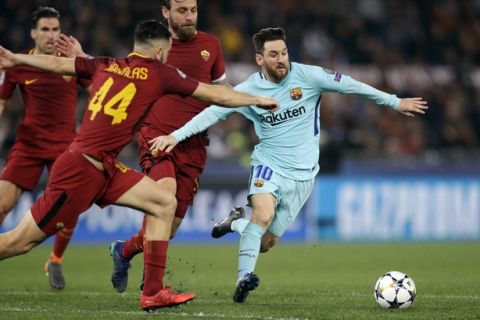 Barcelona's Lionel Messi, right, is challenged by Roma's Kostas Manolas during the Champions League quarterfinal second leg soccer match between Roma and FC Barcelona at Rome's Olympic Stadium, Tuesday, April 10, 2018. (AP Photo/Andrew Medichini)