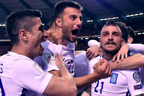 Greece's Andreas Samaris, center, celebrates with team mates after Greece scored a first match goal during the Euro 2018 Group H qualifying match between Belgium and Greece at the King Baudouin stadium in Brussels on Saturday, March 25, 2017. (AP Photo/Geert Vanden Wijngaert)