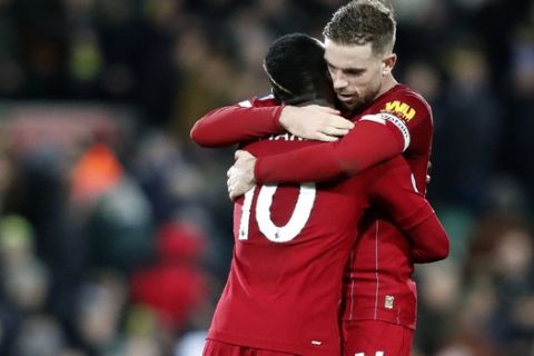 Liverpool's Sadio Mane, left, and Liverpool's Jordan Henderson celebrate at the end of the English Premier League soccer match between Norwich City and Liverpool at Carrow Road Stadium in Norwich, England, Saturday, Feb. 15, 2020. (AP Photo/Frank Augstein)