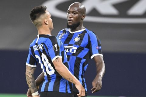 Inter Milan's Romelu Lukaku celebrates after scoring his side's first goal with Inter Milan's Lautaro Martinez during the Europa League round of 16 soccer match between Inter Milan and Getafe at the Veltins-Arena in Gelsenkirchen, Germany, Wednesday, Aug. 5, 2020. (Ina Fassbender, Pool Photo via AP)