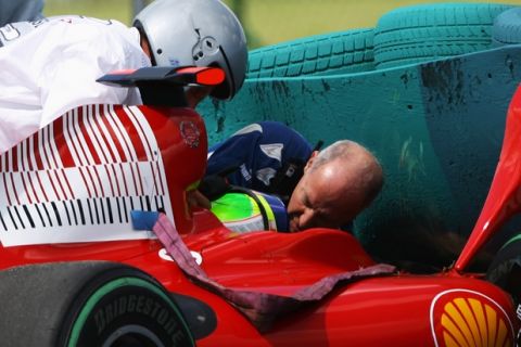 BUDAPEST, HUNGARY - JULY 25:  Felipe Massa of Brazil and Ferrari is attended to by F.I.A. doctor Gary Hartstein, medical staff and marshalls following his accident during qualifying for the Hungarian Formula One Grand Prix at the Hungaroring on July 25, 2009 in Budapest, Hungary.  (Photo by Paul Gilham/Getty Images)