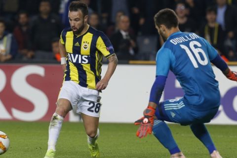Fenerbahce's Mathieu Valbuena, left, in front of Anderlecht's goalkeeper Thomas Didillon, right, passes the ball to his teammate Michael Frey to score, during the group D Europa League soccer match between Fenerbahce and Anderlecht at the Sukru Saracoglu stadium, in Istanbul, Thursday, Nov. 8, 2018. Fenerbahce won the match 2-0. (AP Photo/Lefteris Pitarakis)