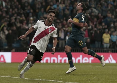 Gonzalo Martinez of Argentina's River Plate, left, celebrates after scoring his team's third goal against Argentina's Boca Juniors during the second half of overtime of the Copa Libertadores final soccer match at the Santiago Bernabeu stadium in Madrid, Spain, Monday, Dec. 10, 2018. (AP Photo/Thanassis Stavrakis)