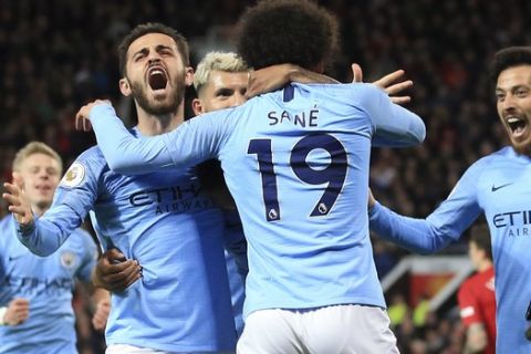 Manchester City's Leroy Sane, 2nd right, celebrates after scoring his side's second goal during the English Premier League soccer match between Manchester United and Manchester City at Old Trafford Stadium in Manchester, England, Wednesday April 24, 2019. (AP Photo/Jon Super)