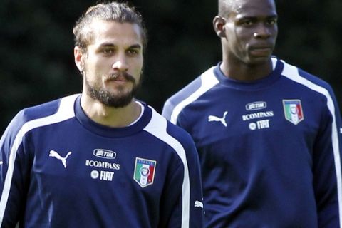 Italy's Dani Osvaldo, left, and Mario Balotelli arrive for a training session at the Coverciano training center near Florence, Wednesday, Nov. 13, 2013. Italy will play two friendly matches with Germany and Nigeria, on Nov. 15 and 18. (AP Photo/Fabrizio Giovannozzi)