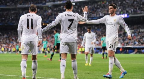 MADRID, SPAIN - MARCH 18:  Cristiano Ronaldo of Real Madrid celebrates with teammates Gareth Bale (L) and Alvaro Morata (R) after scoring his team's second goal during the UEFA Champions League Round of 16, second leg match between Real Madrid and FC Schalke 04 at Estadio Santiago Bernabeu on March 18, 2014 in Madrid, Spain.  (Photo by Denis Doyle/Getty Images)