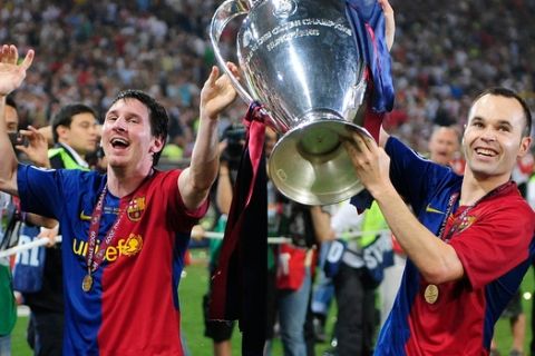 FILE - In this May 27, 2009, file photo, Barcelona's Andres Iniesta, right, and Lionel Messi hold the trophy at the end of the Champions League final soccer match between Manchester United and Barcelona in Rome. (AP Photo/Manu Fernandez, File)