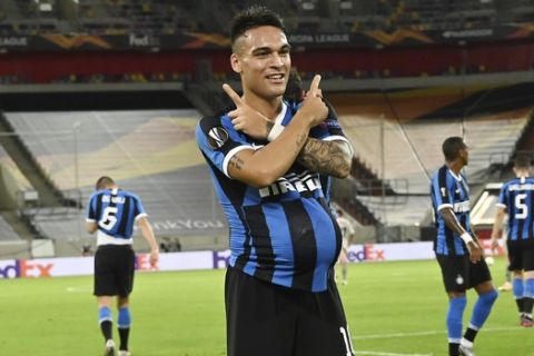Inter Milan's Lautaro Martinez celebrates after scoring his side's opening goal during the Europa League semifinal soccer match between Inter Milan and Shakhtar Donetsk at Dusseldorf Arena, in Duesseldorf, Germany, Monday, Aug. 17, 2020. (Sascha Steinbach, Pool Photo via AP)